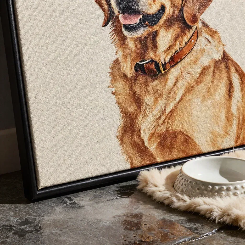 Macro of a framed pet portrait canvas on wet stone with bowl, collar and felt mat.